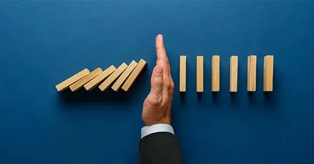 Hand stopping domino effect