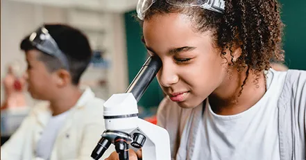 Child using microscope