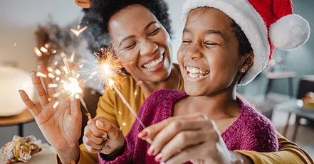 Mother and daughter using sparklers
