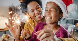 Mother and daughter using sparklers
