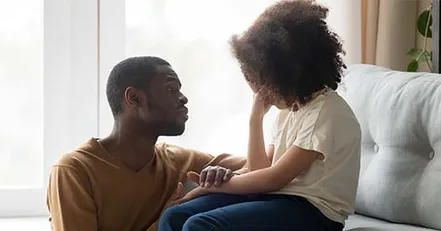 Father talking to upset daughter