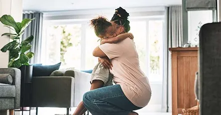 Mother hugging daughter
