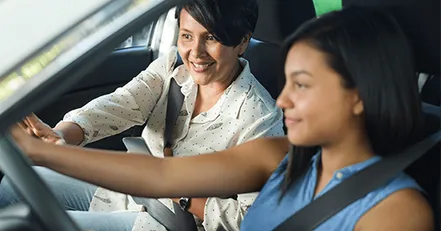 Mother teaching daughter to drive