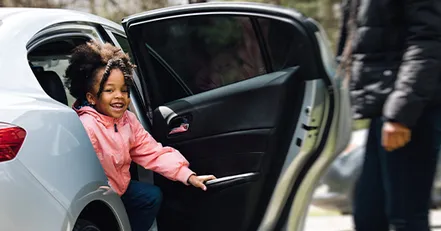 Child getting out of a car