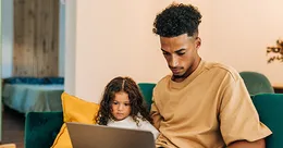 Father and daughter lookign at computer