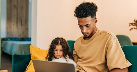 Father and daughter lookign at computer