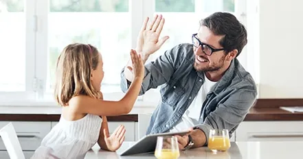 Father and daughter high fiving