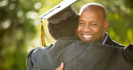 Father hugging graduate