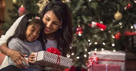 Mother and daughter opening presents