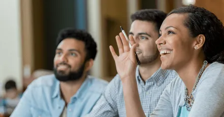 Person holding hand up in class