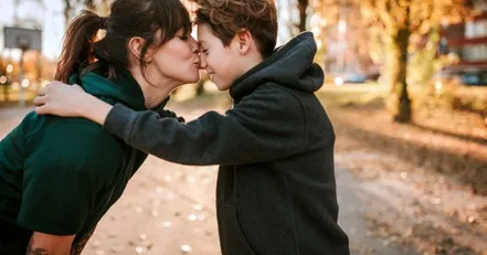 Mother kissing son on the nose