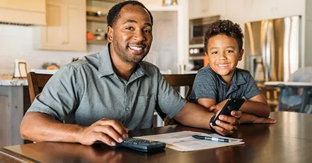 Father teaching son to budget