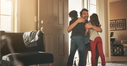 Father hugging children